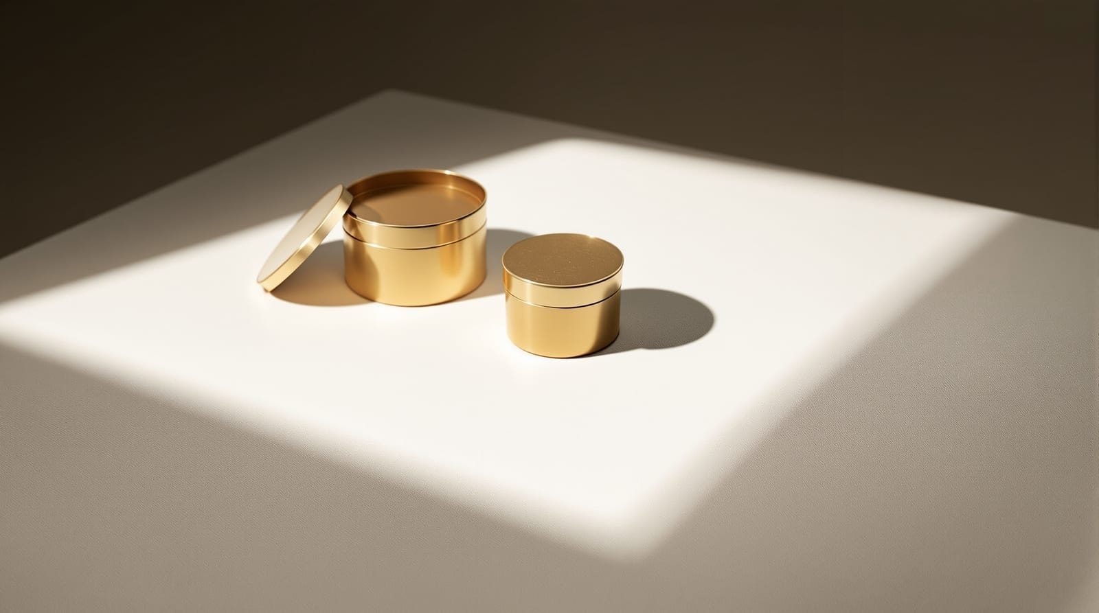 Three nested brass boxes on linen, lit from one side